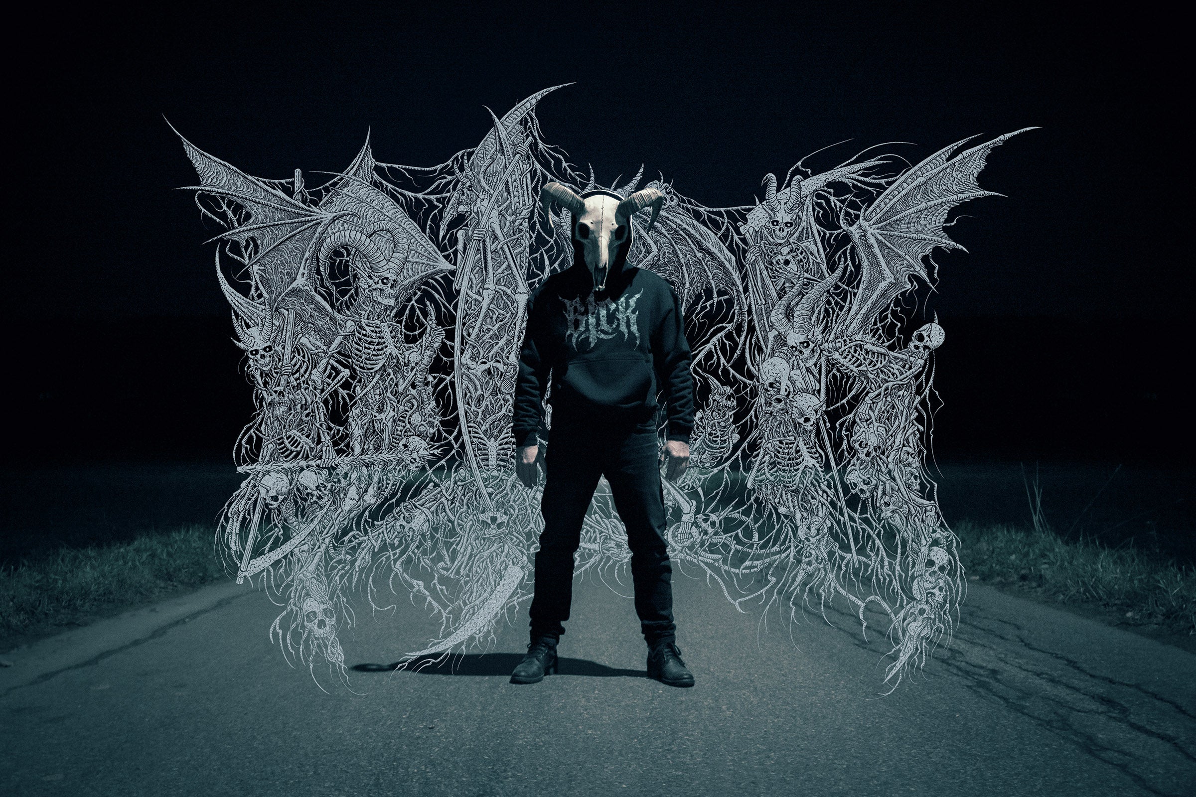Person wearing a goat skull mask and a dark hoodie with a logo, standing in front of intricate demonic skeletons artwork.