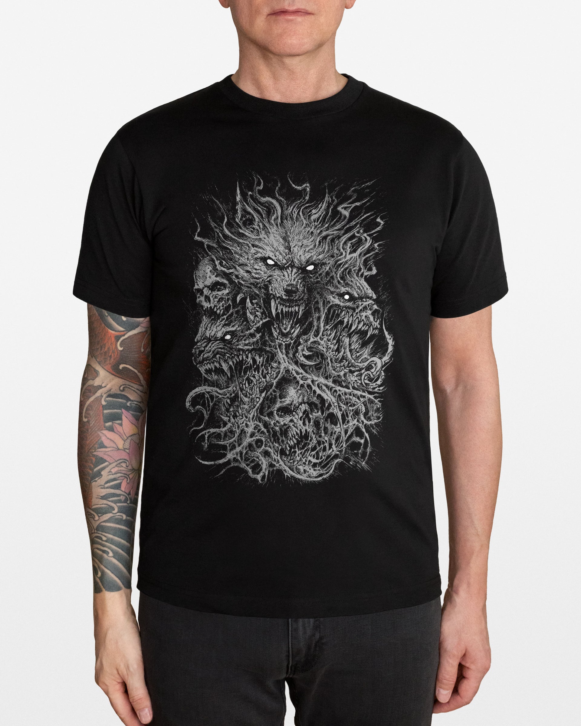Person wearing a black t-shirt with a graphic design of a wolf and skulls on a white background