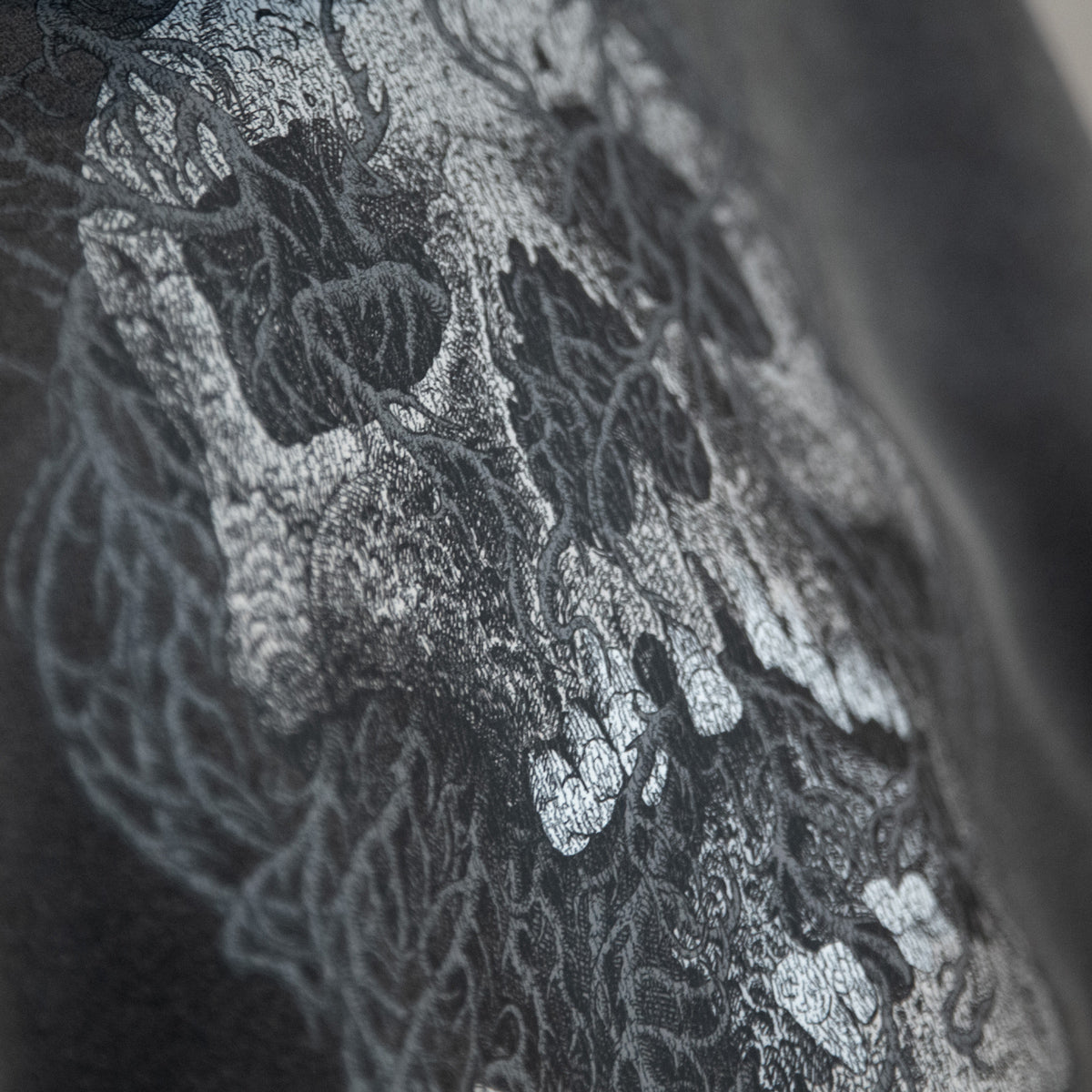 Close-up of a detailed skull illustration printed on fabric.