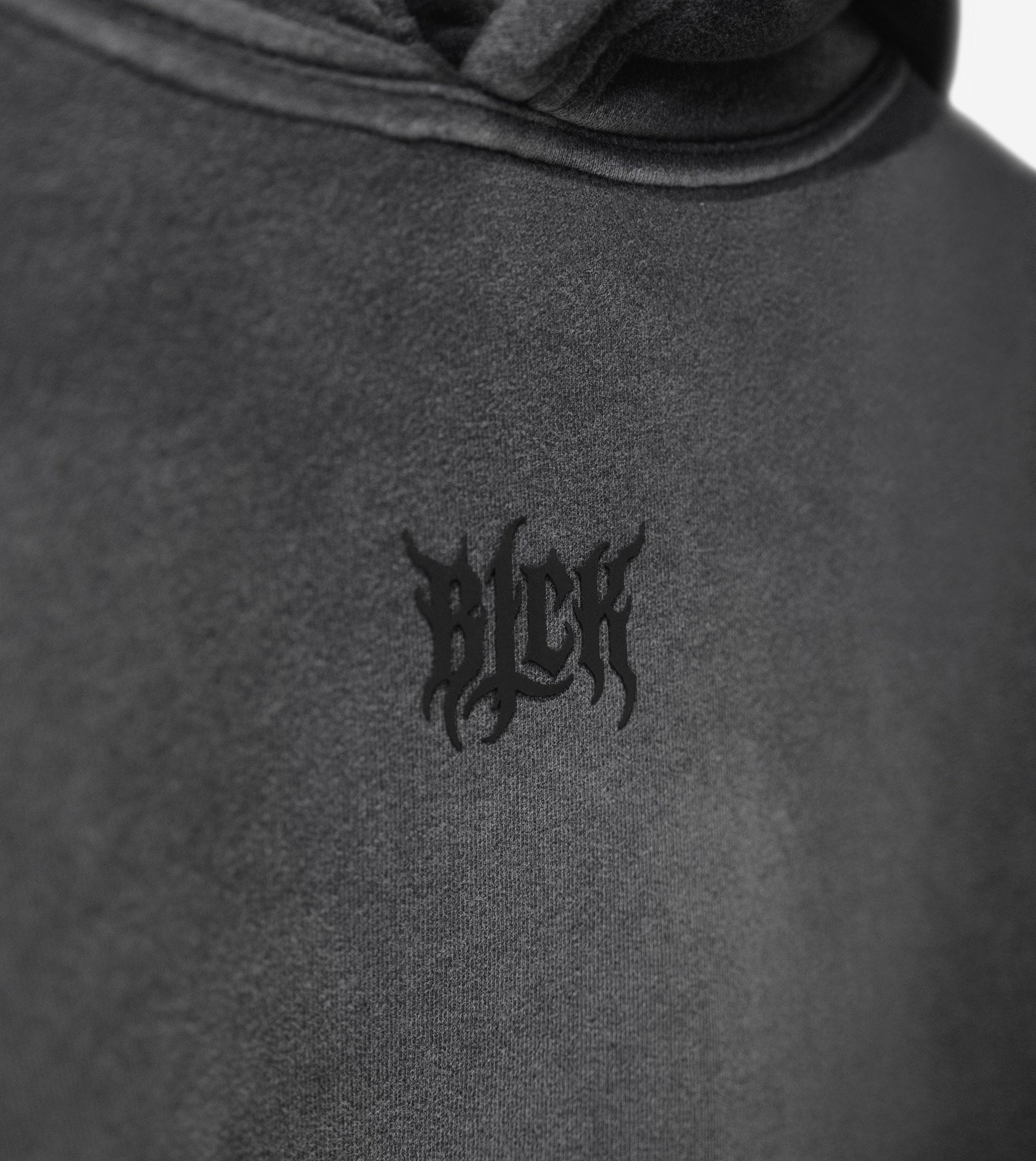 Gray sun faded hoodie with a BLCK logo on the chest