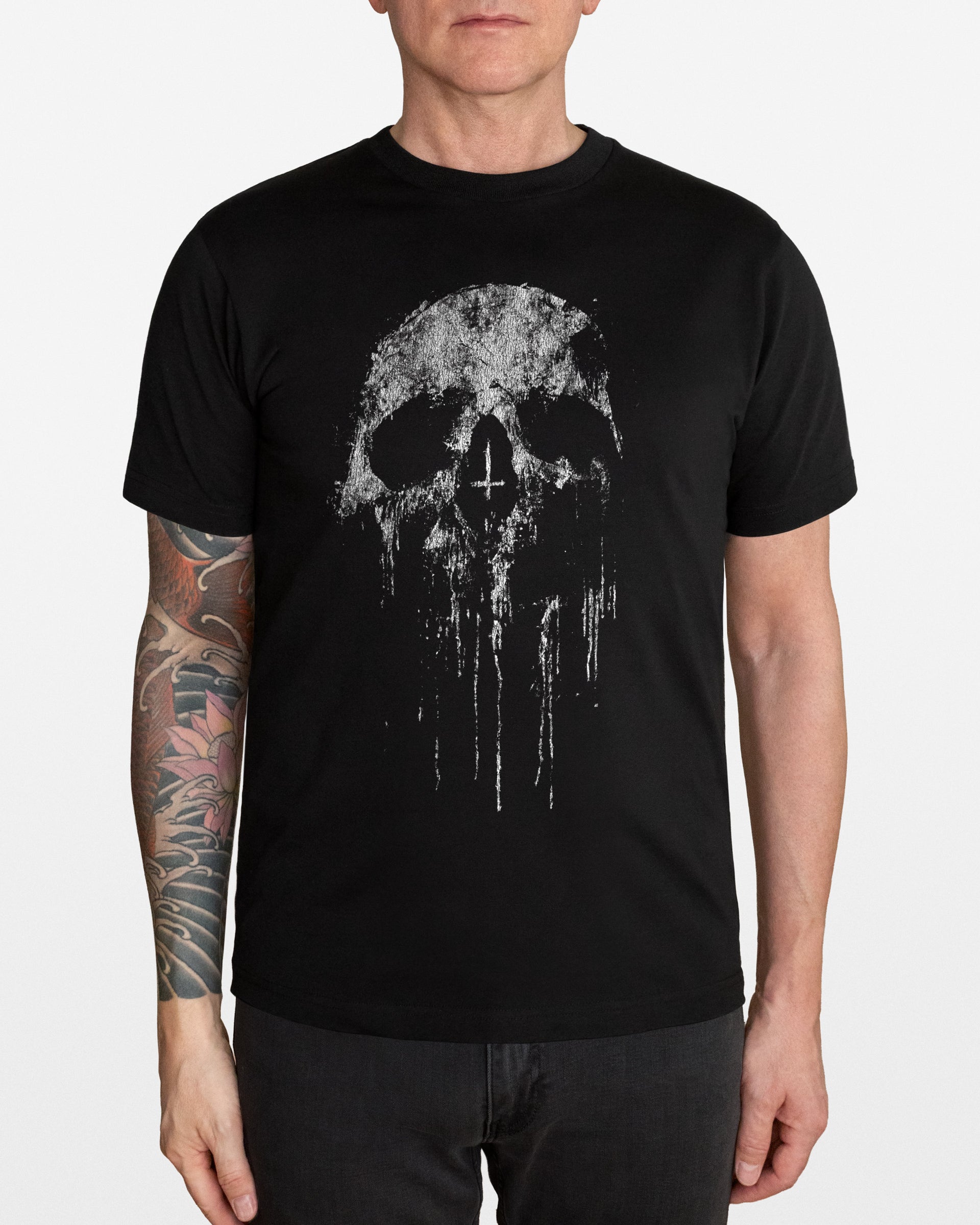Person wearing a black t-shirt with a skull design on a white background