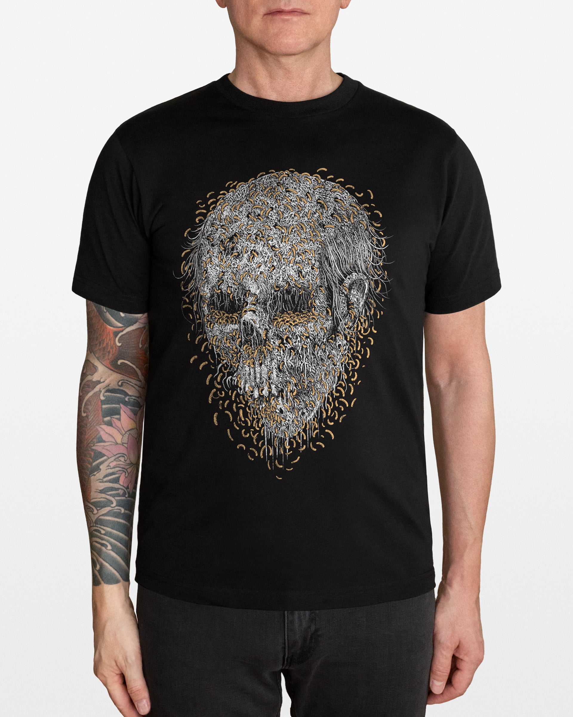 Person wearing a black t-shirt with a detailed maggots skull design, on a white background
