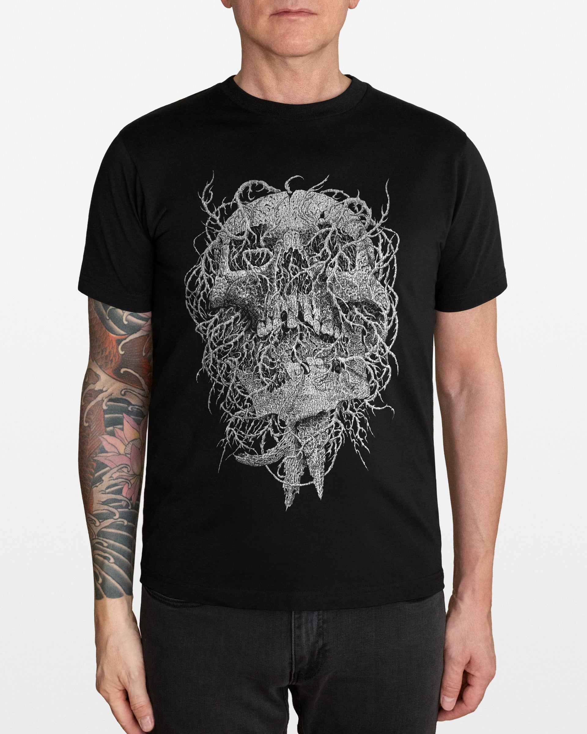 Person wearing a black t-shirt with an intricate white skull design on a white background