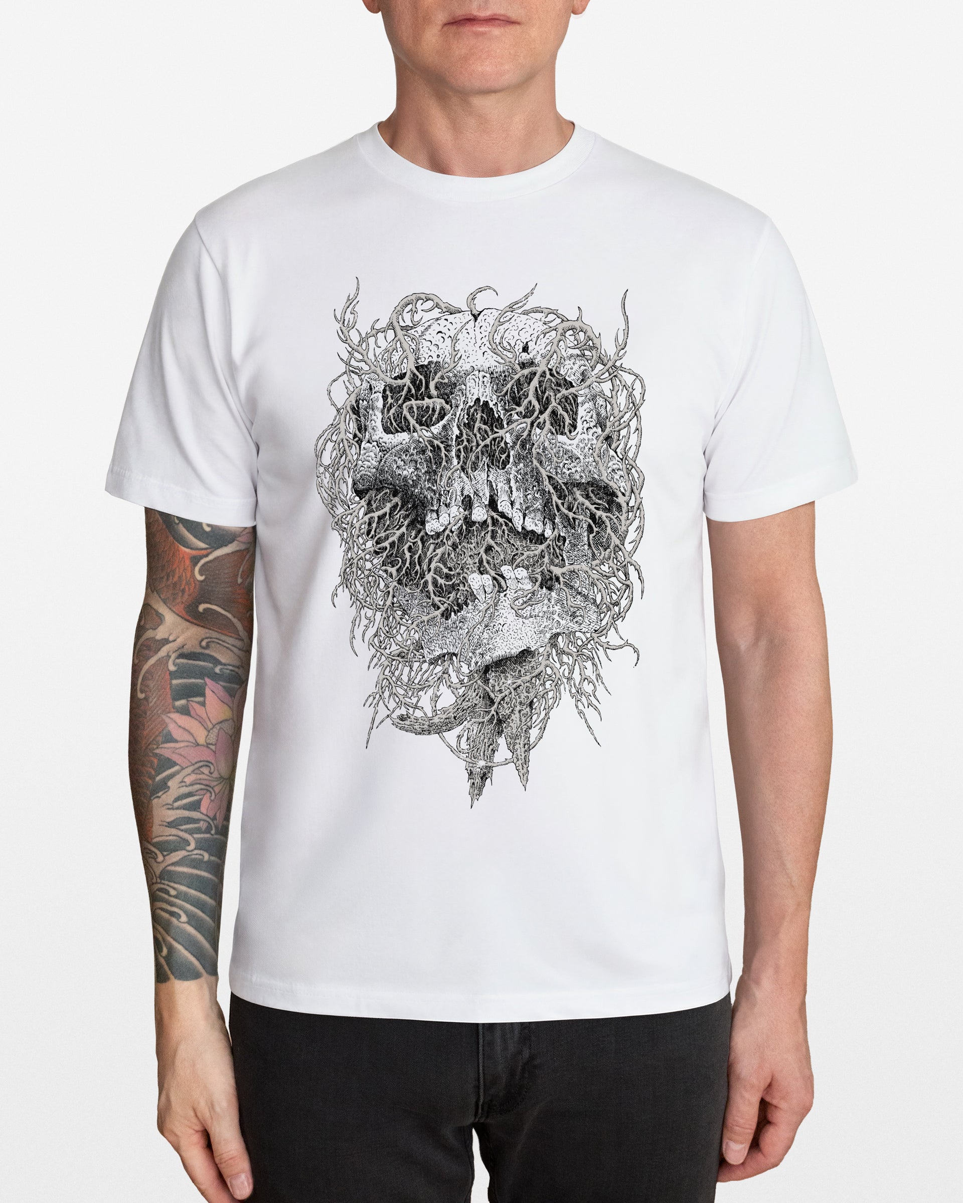 Person wearing a white t-shirt with a black and gray skull design on a plain background